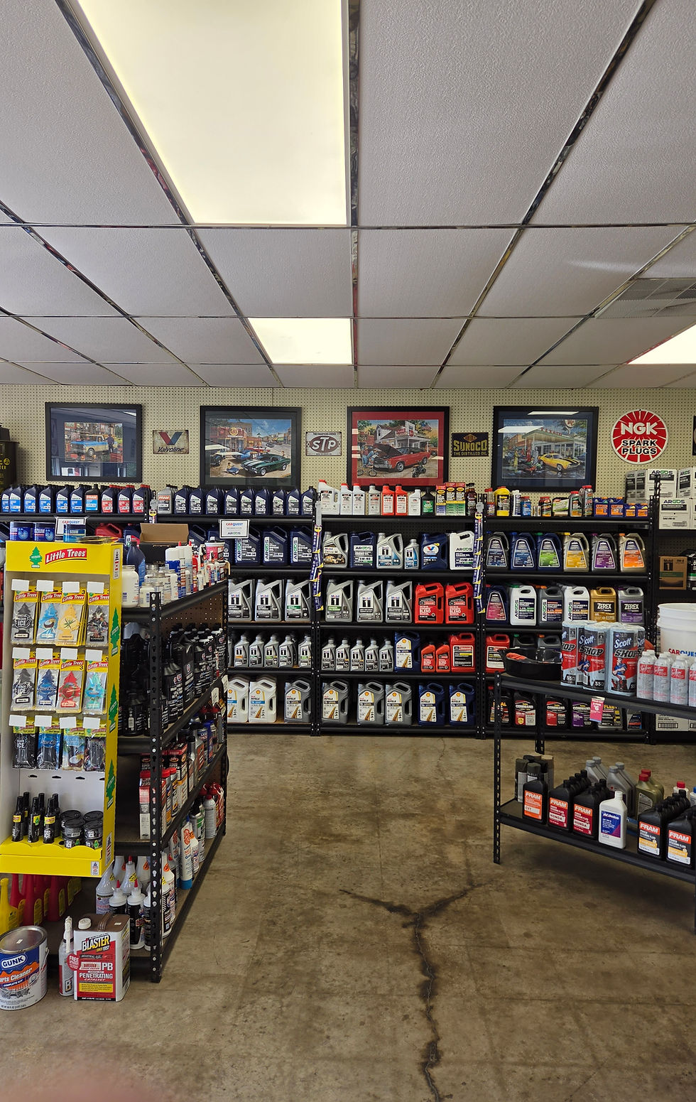 Shelves stocked with various auto parts and fluids