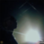 silhouette of man with black background with spotlight