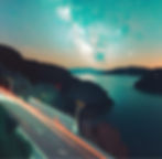 a road and the milky way at the background