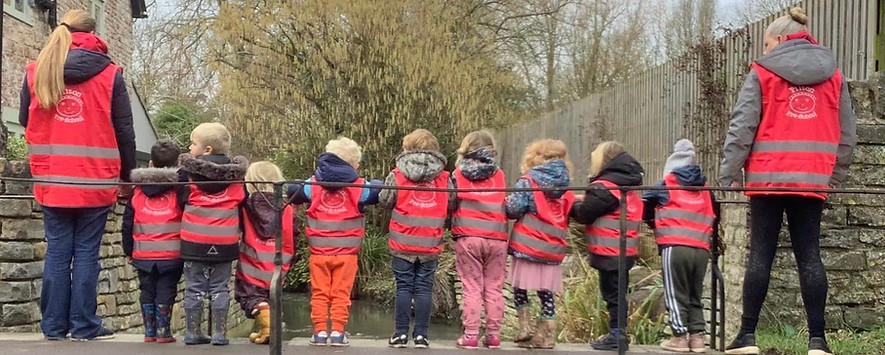 Preschool children and staff walking near Pilton ford
