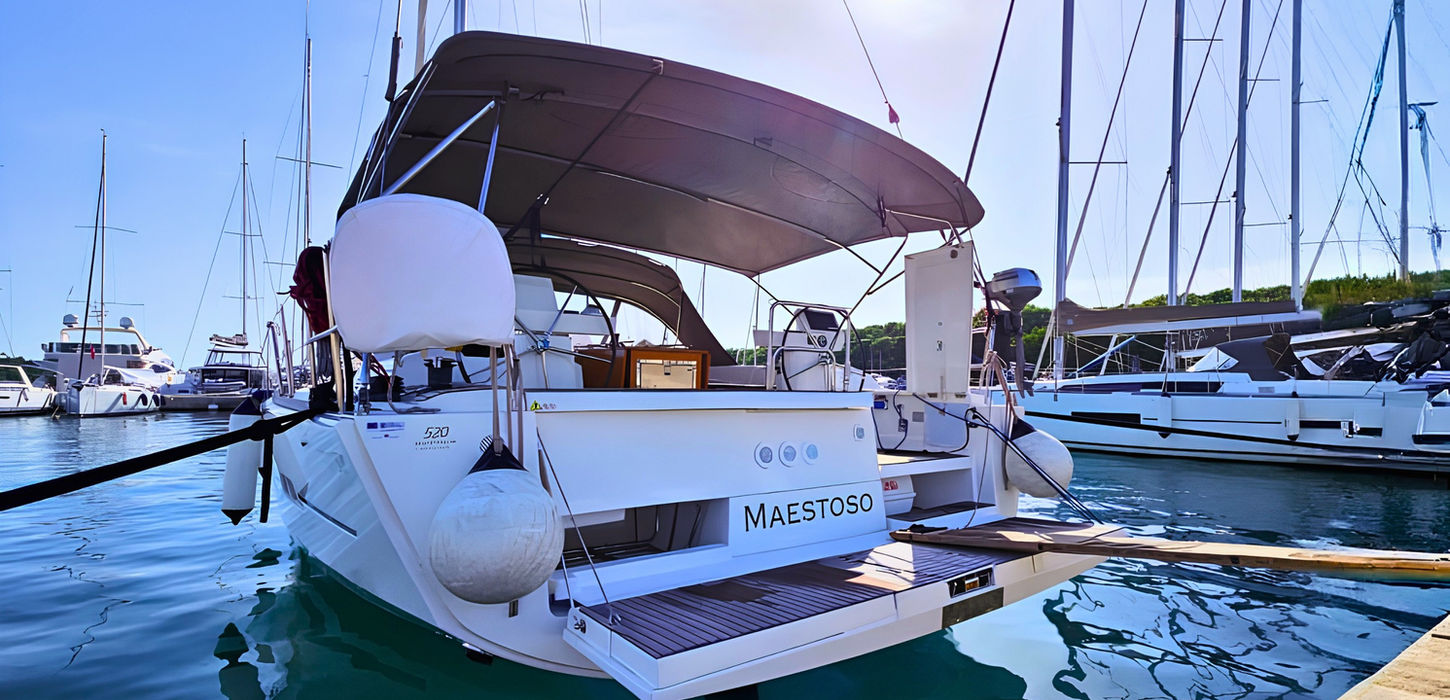 Maestoso Dufour 52 GL sailing yacht stern view at marina in Crete
