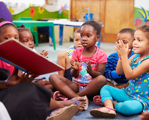 Teacher reading a book with a class of preschool children.jpg