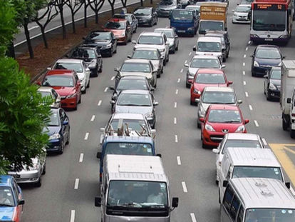 How many green cars are there on the road?