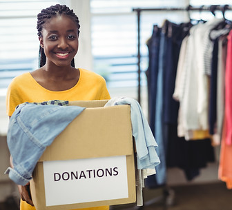 female-volunteer-holding-clothes-donation-box.jpg
