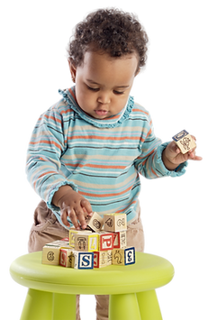 Toddler at table playing with toys - KINGDOM KIDZ ACADEMY