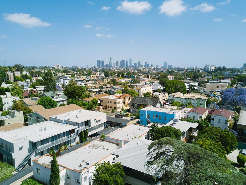 Sunny landspace image of LA homes and skyline in the background - K2 investment Inc