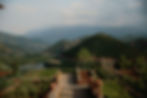 Panoramic view of a Moroccan retreat garden surrounded by the Atlas Mountains, offering participants a peaceful escape during a transformative equestrian journey