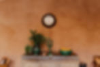 Rustic Moroccan decor with handcrafted ceramics and natural elements displayed on a vintage wooden sideboard, evoking the cultural essence of the retreat setting
