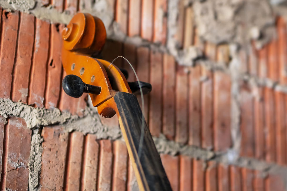 A beautiful violin is elegantly hanging on a rugged brick wall, creating a striking contra