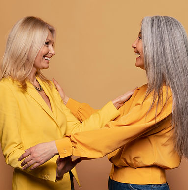 senior-women-holding-each-other-against-yellow-background_edited_edited.jpg