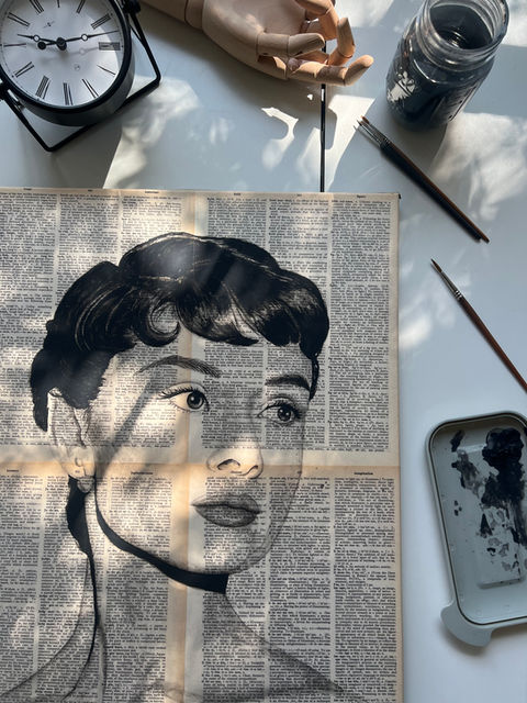 acrylic painting of Audrey Hepburn on a page from "The Lexicon Webster Dictionary" published in 1983