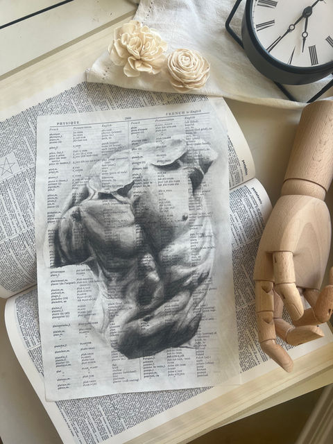charcoal drawing of a statue of a man's torso on a page from "Webster's Third New International Dictionary" published in 1976