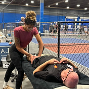 Whitney crawford at the Queen City pickle ball up providing a sports massage