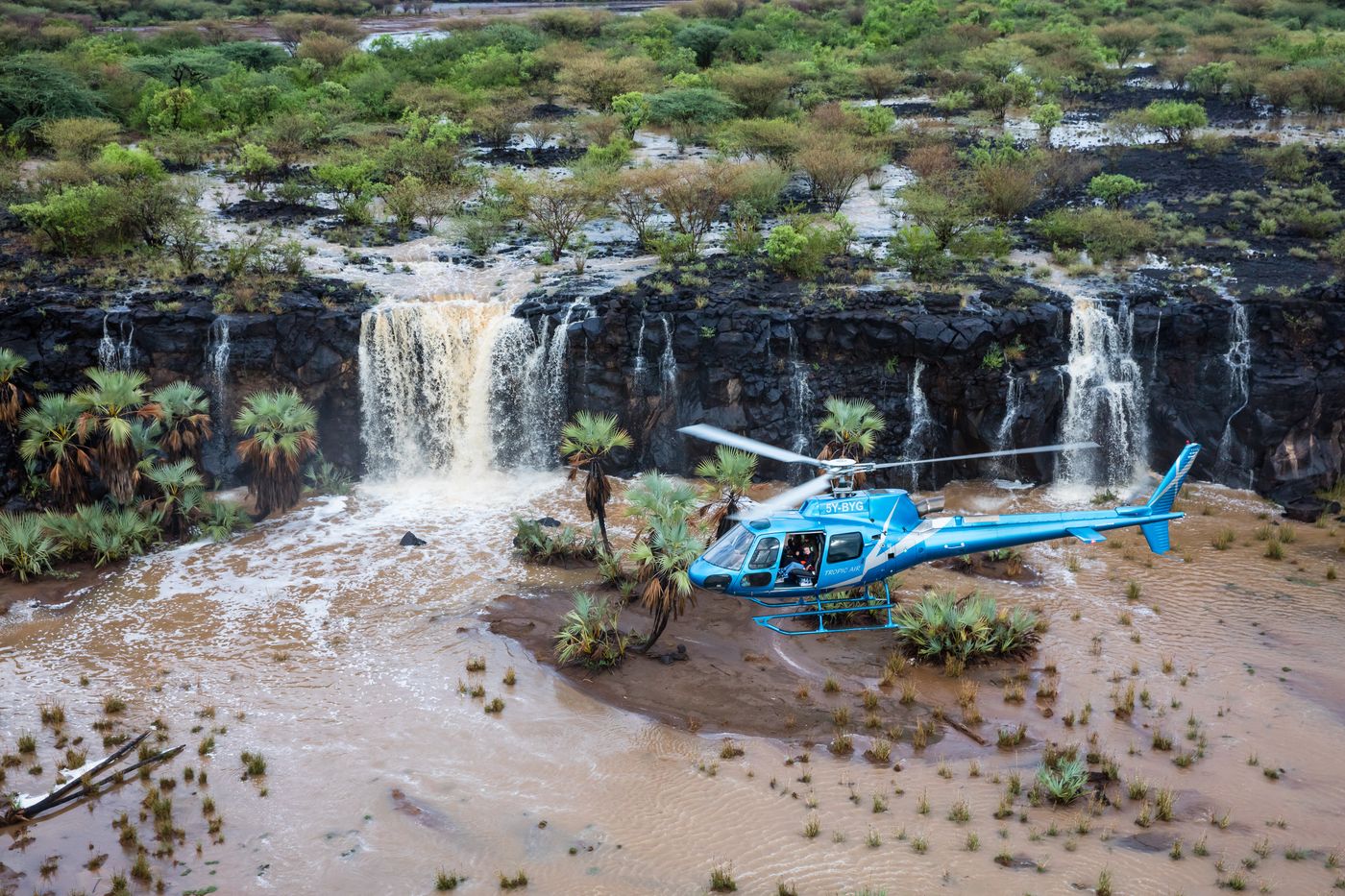 Helicopter landed in front of a waterfall in northern Kenya