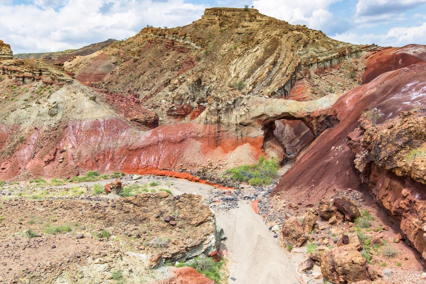 Natural rock arch in red and ochre badlands, northern Kenya
