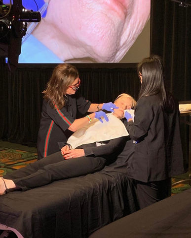 two female doctors working on patient on a stage