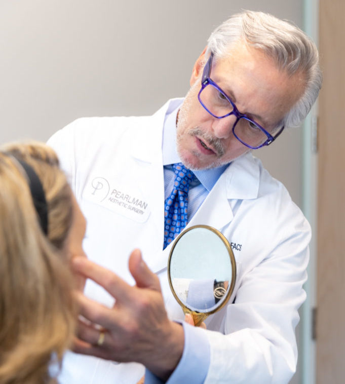 Dr Pearlman giving female patient surgical consultation