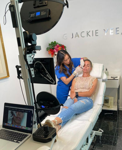 doctor performing and filming aesthetic procedure