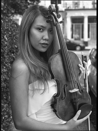 Portrait of a young female musician holding her violin on the streets of London | I am your mirror