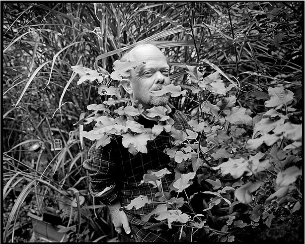 Portrait of a dwarf emerging from a bunch of vegetation | love, sex and relationships