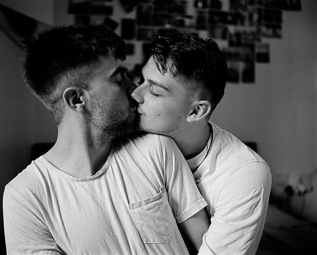 Portrait of two young men kissing in the intimacy of their home | love, sex and relationships