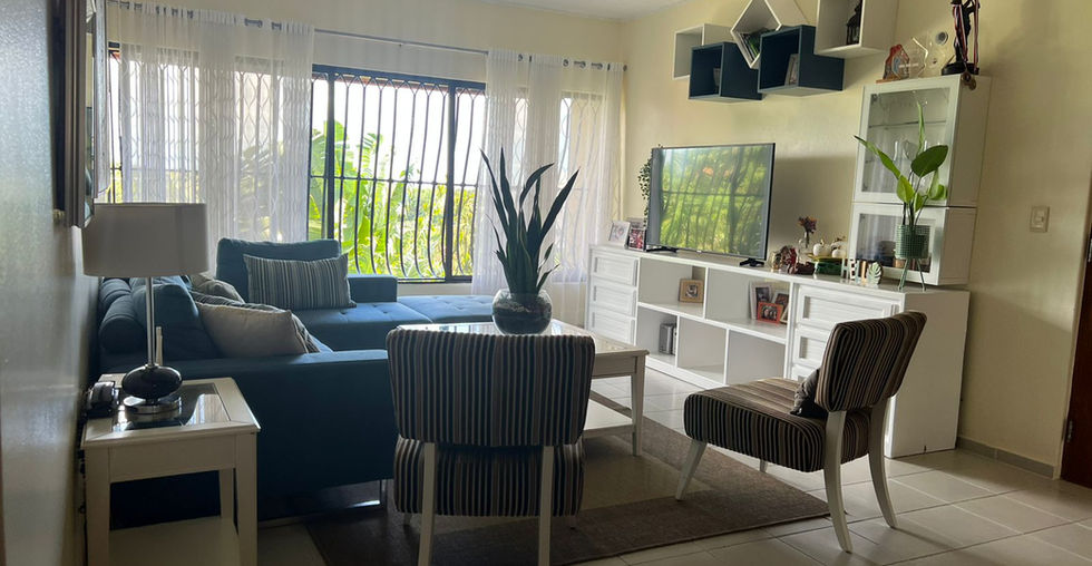 Step into the inviting living room flooded with natural light and generous space, creating a warm and welcoming ambiance.