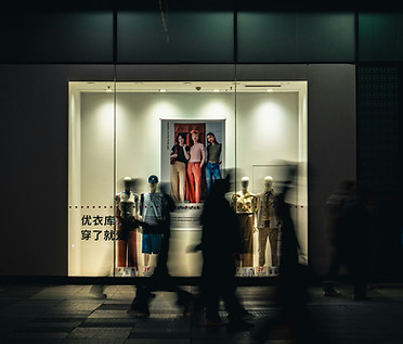 Clothing storefront with silhouettes walking by