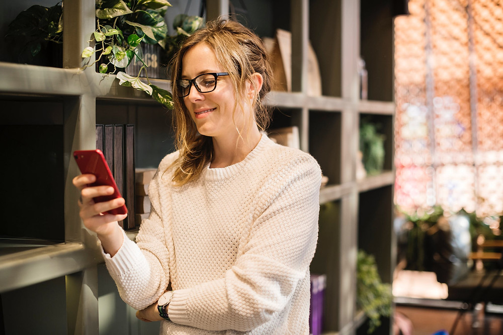woman smiling at her phone
