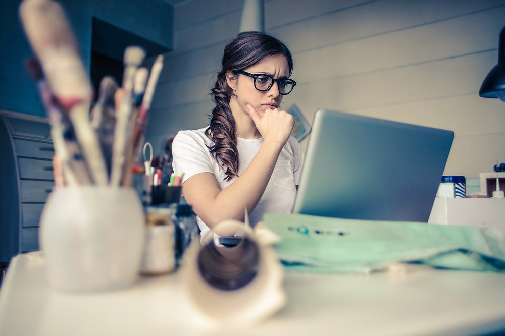 Woman sitting at desk focusing on computer