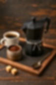 black moka pot with a mug