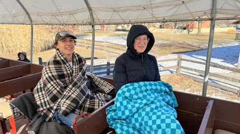 Young Single Adults in blankets before a wagon ride. The Nauvoo Discovery Program Winter 2025 semester participants tour Old Nauvoo Sites