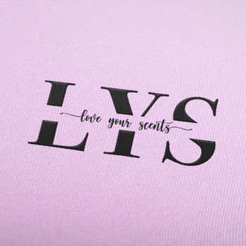 A digital mockup of a logo on a pink background made to look embroidered.