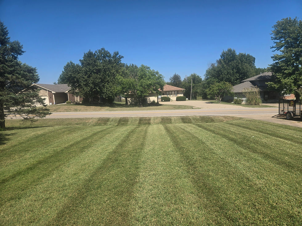 Freshly mowed residential lawn with clean mowing patterns in Topeka, Kansas by Lawn Care Topeka