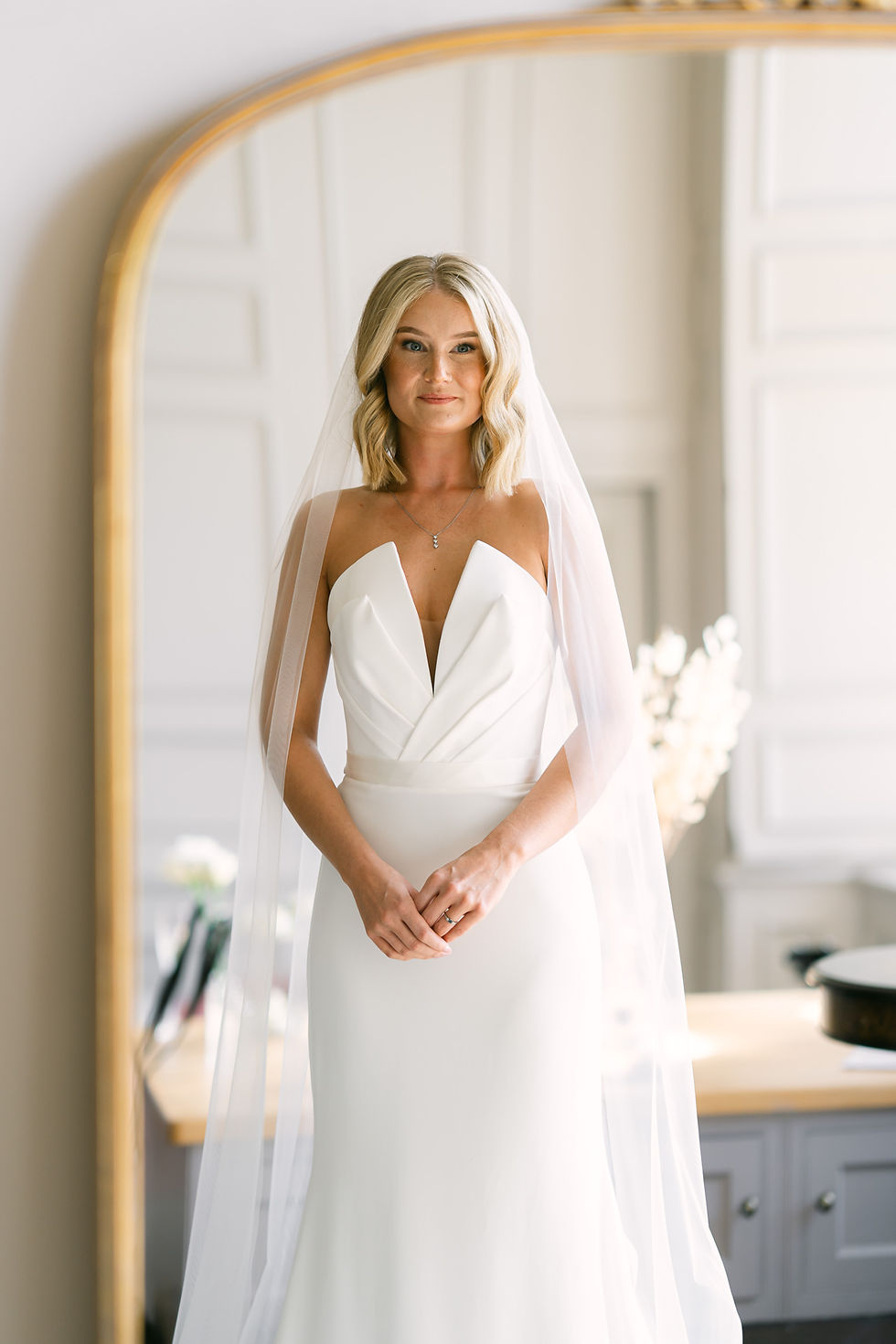 Bride portrait reflected in mirror at Brympton House wedding in Somerset, natural documentary wedding photography