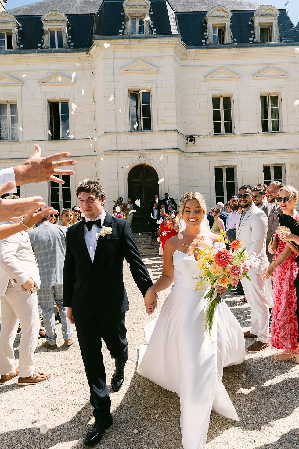 Bride and groom walking through guests at Chateau Fengari wedding in France, natural documentary wedding photography