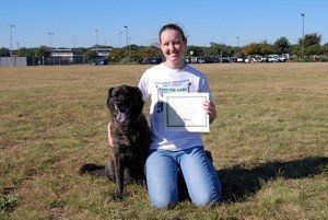 Amanda and Shadow with an obedience training certificate