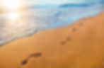 beach, wave and footprints at sunset time.jpg