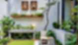 Small space gardening with potted plants and vertical planters on a balcony.