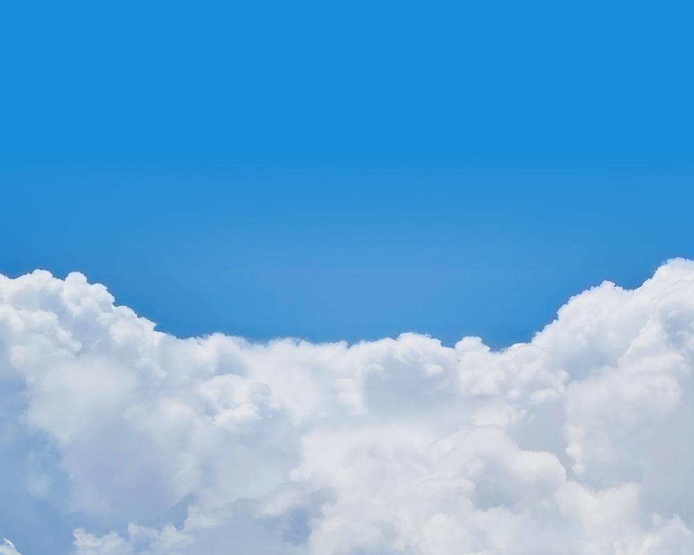 Peaceful blue sky with soft white clouds, framing a sun and kites above the horizon.