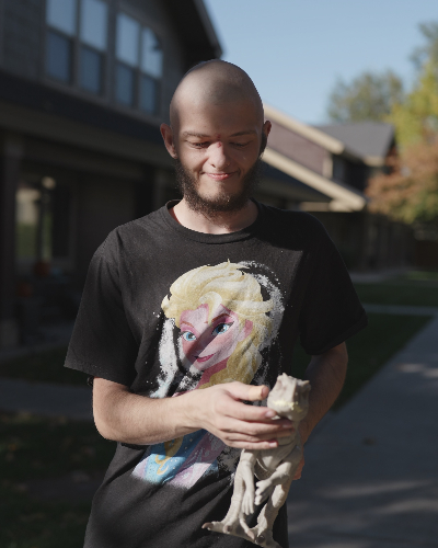 Portrait of Kody holdng his favorite toy dinosaur. He is a CBRS client at Visions Counseling & Education in Boise.