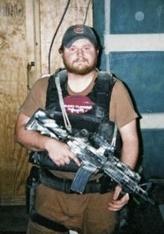 Portrait of Richard Renz, DHS, LMSW at Visions Counseling & Education | CBRS in Boise holding a military rifle during a military deployment.