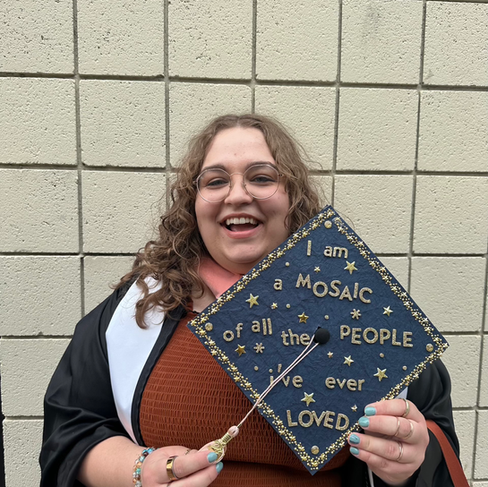 Portrait of Bryn Winegar, LPC at Visions Counseling & Education in Boise holding her cap with a message that states: I am a mosaic of all the people I've ever loved.