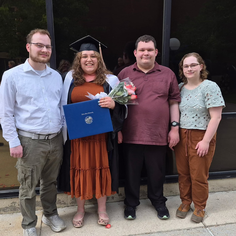 Portrait of Bryn Winegar, LPC at Visions Counseling & Education in Boise posing with her family after graduation.