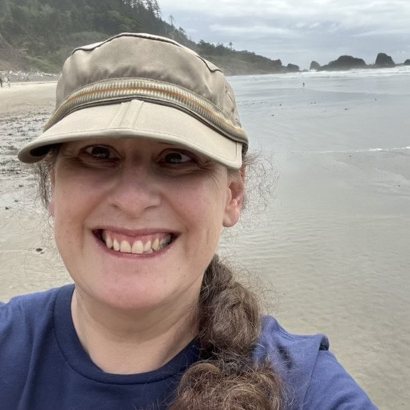 Portrait of Angela Coleman, CBRS and LPC Intern at Visions Counseling & Education | CBRS in Boise seen standing on the beach in Oregon.