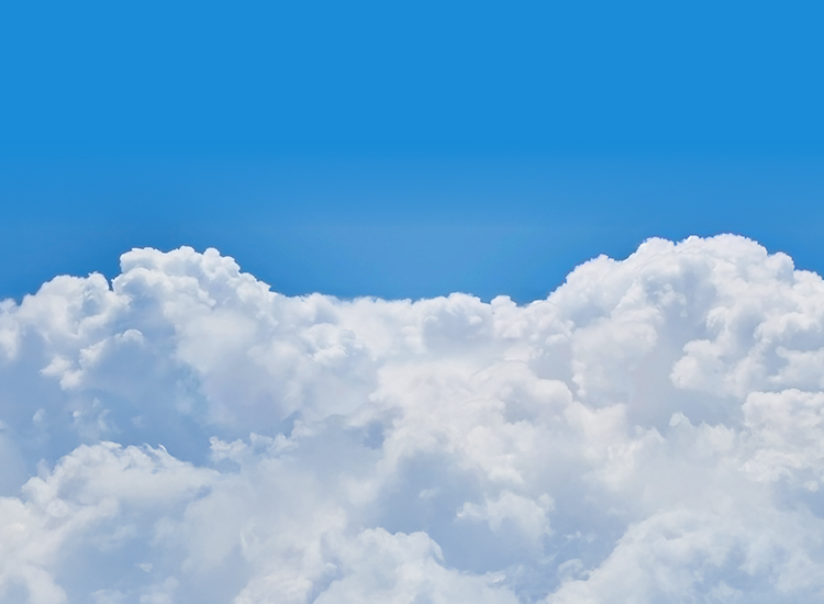 Peaceful blue sky with soft white clouds, framing a sun and kites above the horizon.