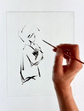 An artist's hand skillfully adds expressive strokes to a minimalist ink drawing, capturing the essence of a figure with elegant simplicity. Hand drawing an abstract figure with black ink on a white paper. Minimalist style, focusing on brushstrokes and simplicity.