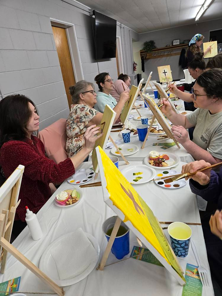 Group of people painting at an art class