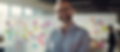 Image of a professional teacher, standing in front of a board of post it notes