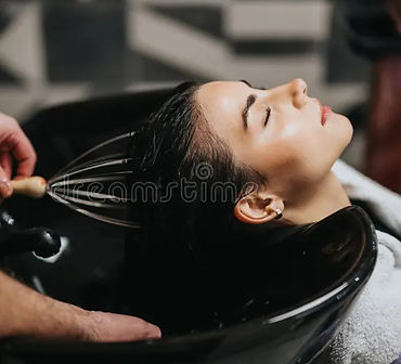 client-reclines-eyes-closed-as-stylist-washes-her-hair-glossy-black-salon-sink-scene-captu