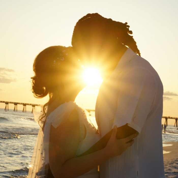 Couple embracing on the beach at sunset